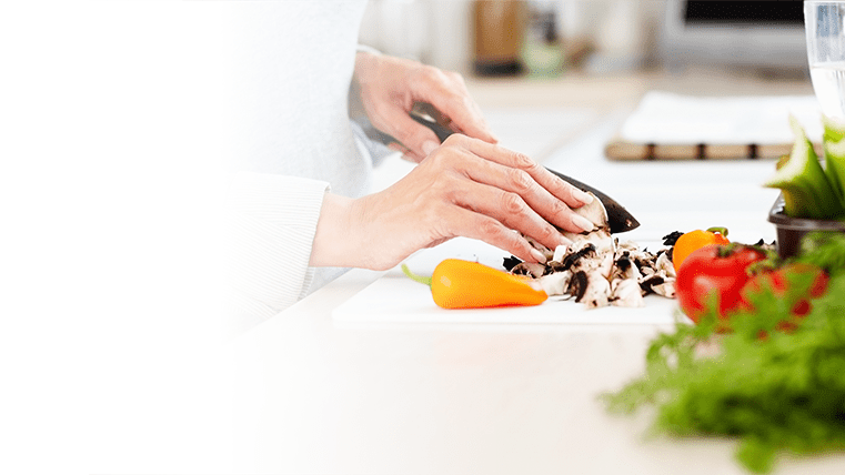 Image of someone cutting mushrooms in a kitchen